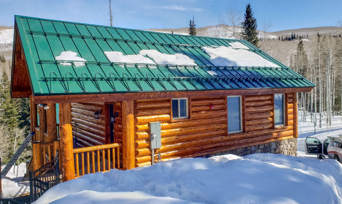 cabin with snow retention and heat tape with mounted controller